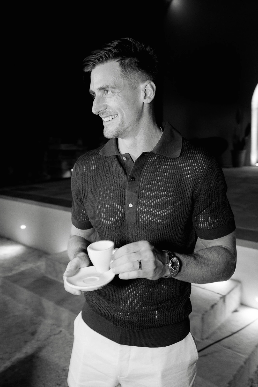A guest savors an evening espresso beneath the Italian night sky, his smile reflecting the warmth of a Puglian celebration.