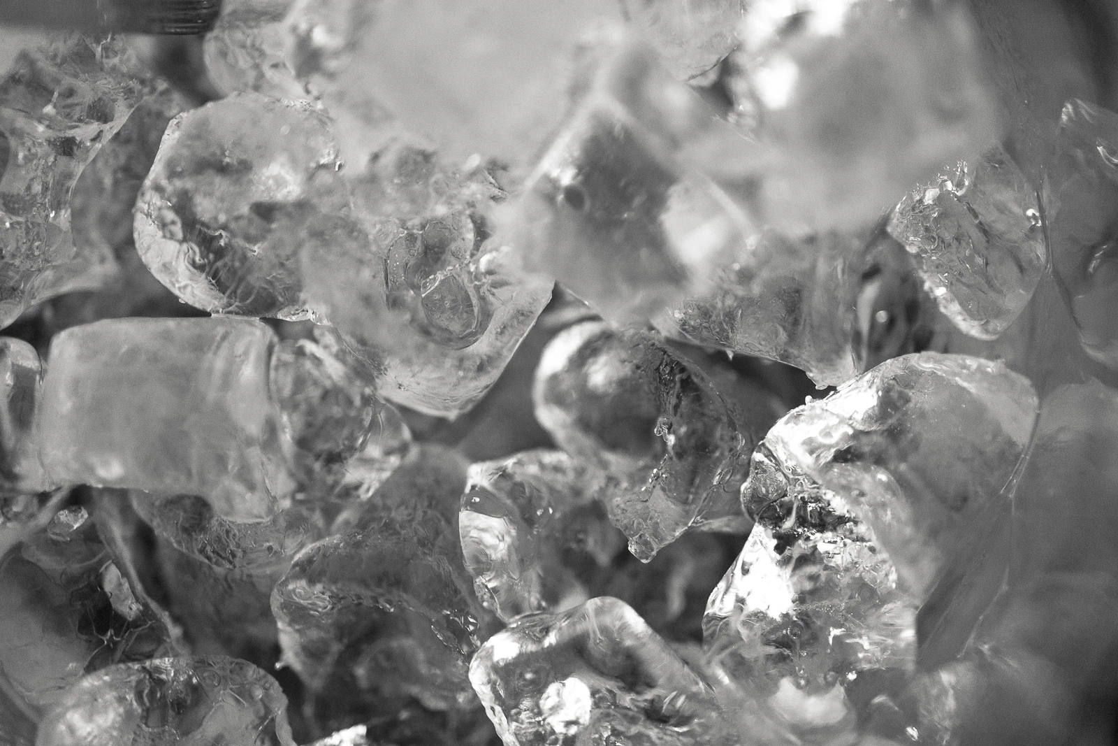 A close-up of crystalline ice cubes evokes refined celebrations in Puglia, their textures glistening with elegant simplicity.