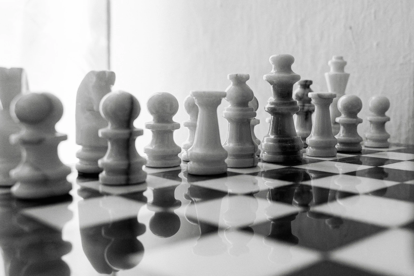 In elegant black and white, chess pieces on a board evoke timeless romance—an intimate Puglia wedding moment unfolding.